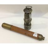 A wooden-sleeved single-drawer brass telescope, with forward sliding object lens shade and sliding