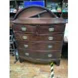 A George III mahogany veneered bow-front chest of drawers, with brass handles, on shaped bracket