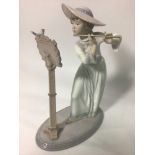 A Lladro porcelain figure of a lady playing the flute, 'Songbird No. 6093', signed to base, 24cm