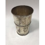 An Edwardian silver and silver-gilt beaker of tapering cylindrical form, with three horizontal bands