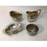 Four assorted items of silver including a Georgian jug, a pierced dish and a cup by Mappin & Webb (