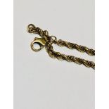 A 9ct yellow gold rope chain, measuring 22 inches in length and weighing 8.5 grams.