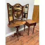 A mahogany Pembroke table raised on turned supports together with a swivel topped oval drop leaf