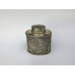 A Victorian Silver Tea Caddy by George Nathan & Ridley Hayes, with repousse decoration of putti in a