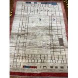 A traditional hand made gabbeh extra large wool rug in stone colour with red border, 290 x 204cm