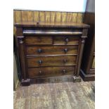 A 19th century flame-mahogany veneered chest with shallow pulvinated top drawer above a pair of