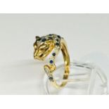 An 18ct yellow gold dress ring, Cartier style in the shape of a leopard, with sapphires, diamonds