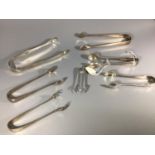Seven assorted pairs of silver sugar tongs including examples by Walker & Hall etc. Gross weight
