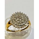 A 9ct gold diamond tiered cluster ring, set with 1.02cts of round brilliant cut diamonds, weighs 3.6