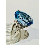 A 9ct white gold blue topaz and diamond dress ring, set with a large oval blue topaz measuring 14