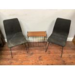 A pair of mid-century Italian style dining chairs covered in a dark grey fabric together with a