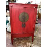 A 19th century Qing dynasty red painted wedding cabinet, constructed from elm and pine, the two