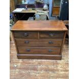 An Edwardian walnut chest of two short and two long graduated drawers with oval brass handles, on