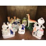 A selection of various Staffordshire spill vases and flatback figures including a castle, courting