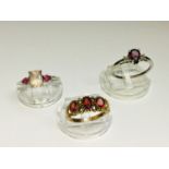 Two 9ct white gold dress rings set with pink and red stones and a yellow gold dress ring set with