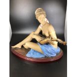 A large Lladro porcelain figure of a semi-clad seated lady playing a lute 'Scheherazade No.