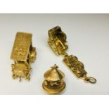 Three 9ct yellow gold novelty charms, including a vintage Daimler car, a moving carousel and a house