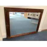 A large rectangular bevelled mirror in ornate gilt-wood and gesso frame with decorative moulded