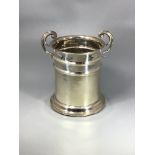 An Edwardian silver wine bottle holder with twin scrolled handles, Birmingham, 1909, maker's mark of