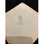 A cotton napkin from the Paris home of Emperor Napoleon III, with his monogram, a white tablecloth