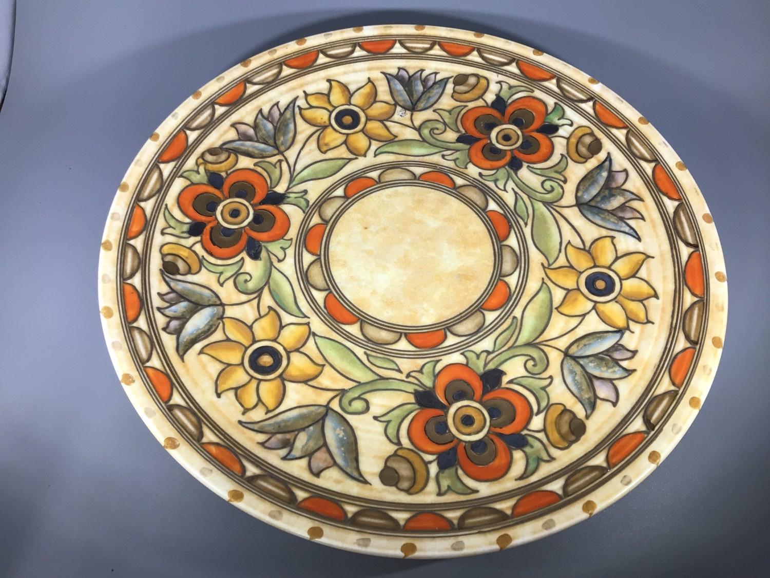 A large Crown Ducal pottery charger by Charlotte Rhead, decorated with scrolling foliage, no.6189 '