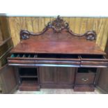 A Victorian chiffonier in flamed mahogany with baize green lined drawer compartment inner trays