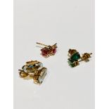Three pairs of earrings, set with peridot, aquamarine and rubies in claw settings, total weight of