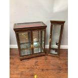 A modern burr-wood effect two-door standing display cabinet with bijouterie table-top enclosing