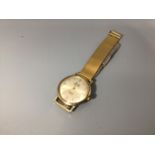 A gents 9ct gold Majex 'Super Slim' wristwatch, the gilt dial with batons denoting hours,