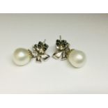 A pair of 18ct white gold diamond and pearl drop earrings in a bow design, total weight 8.0 grams,