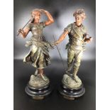 A pair of spelter figures after Faucheur, modelled as male and female agricultural workers