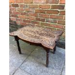 A 20th century carved oak coffee table with leaf display carving on turned legs, 76cm wide, 50cm