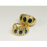 A pair of 18ct yellow gold earrings set with 3 x oval cut sapphires and 40 x round brilliant cut