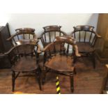 A matched set of five early 20th century Captain style carvers, with elm seats and beech spindled