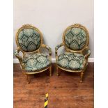 A pair of reproduction Louis XVI style chairs upholstered green and white floral fabric with gold