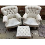 A pair of early 20th century button backed armchairs by Maple & co with mahogany turned legs and