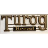 A large early 20th century wooden and wrought iron advertising sign for 'Turog Bread', painted in