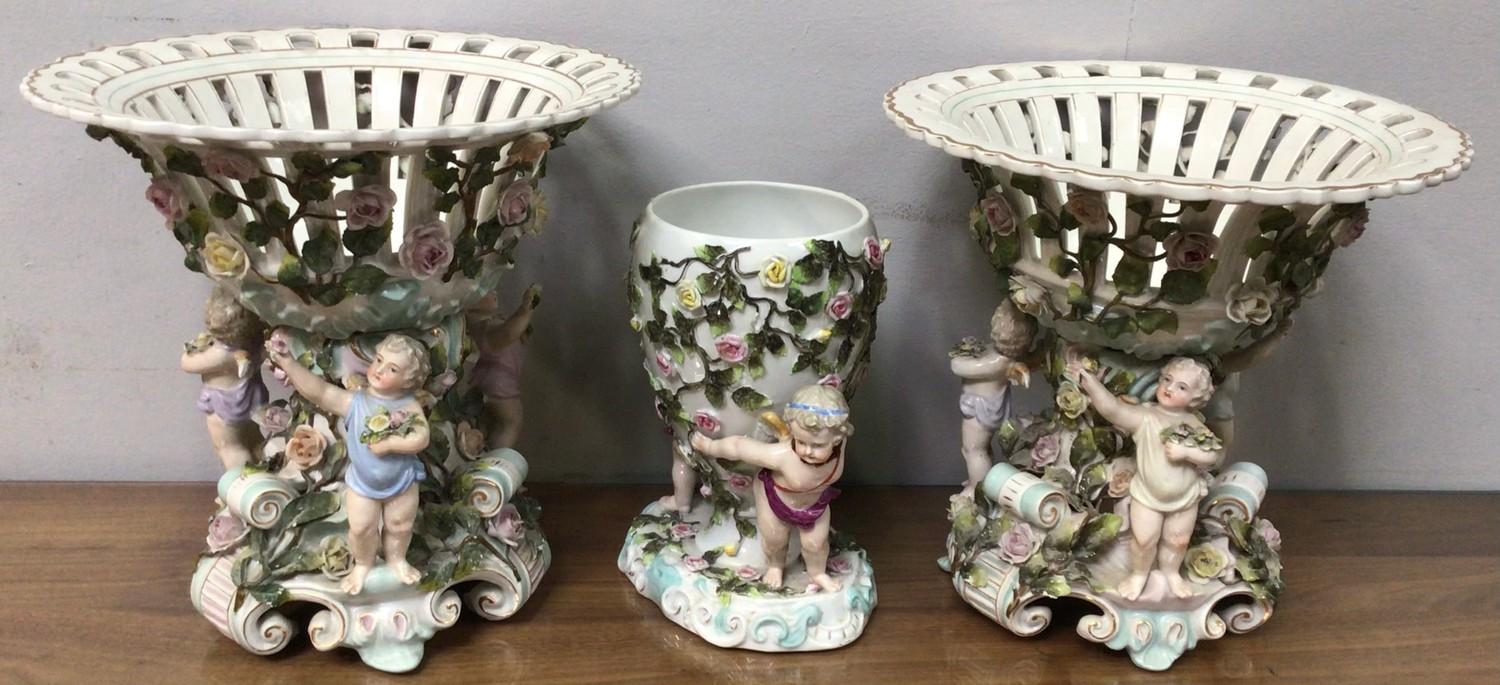 A pair of Sitzendorf figural porcelain comports with pierced bowls, the base with three cherubs - Image 2 of 4