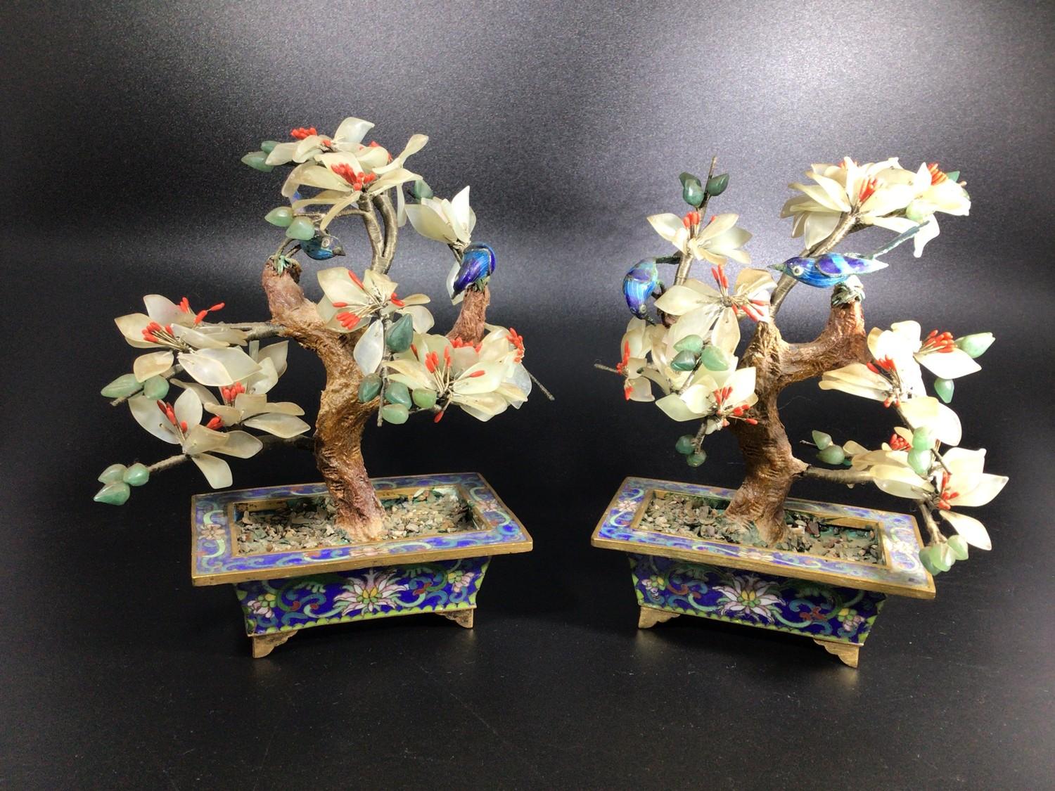 A pair of Oriental cloisonné enamel and hard stone bonsai trees with red, white and green blossom