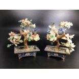 A pair of Oriental cloisonné enamel and hard stone bonsai trees with red, white and green blossom