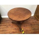 A circular flamed mahogany veneered tilt-top supper table, raised on central tapered column to