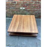 A contemporary square walnut 'C3' coffee table by Team 7, the top with glass protector and raised on