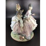 A large Lladro porcelain figure group of three Rococo ladies looking at a small dog 'Three Sisters