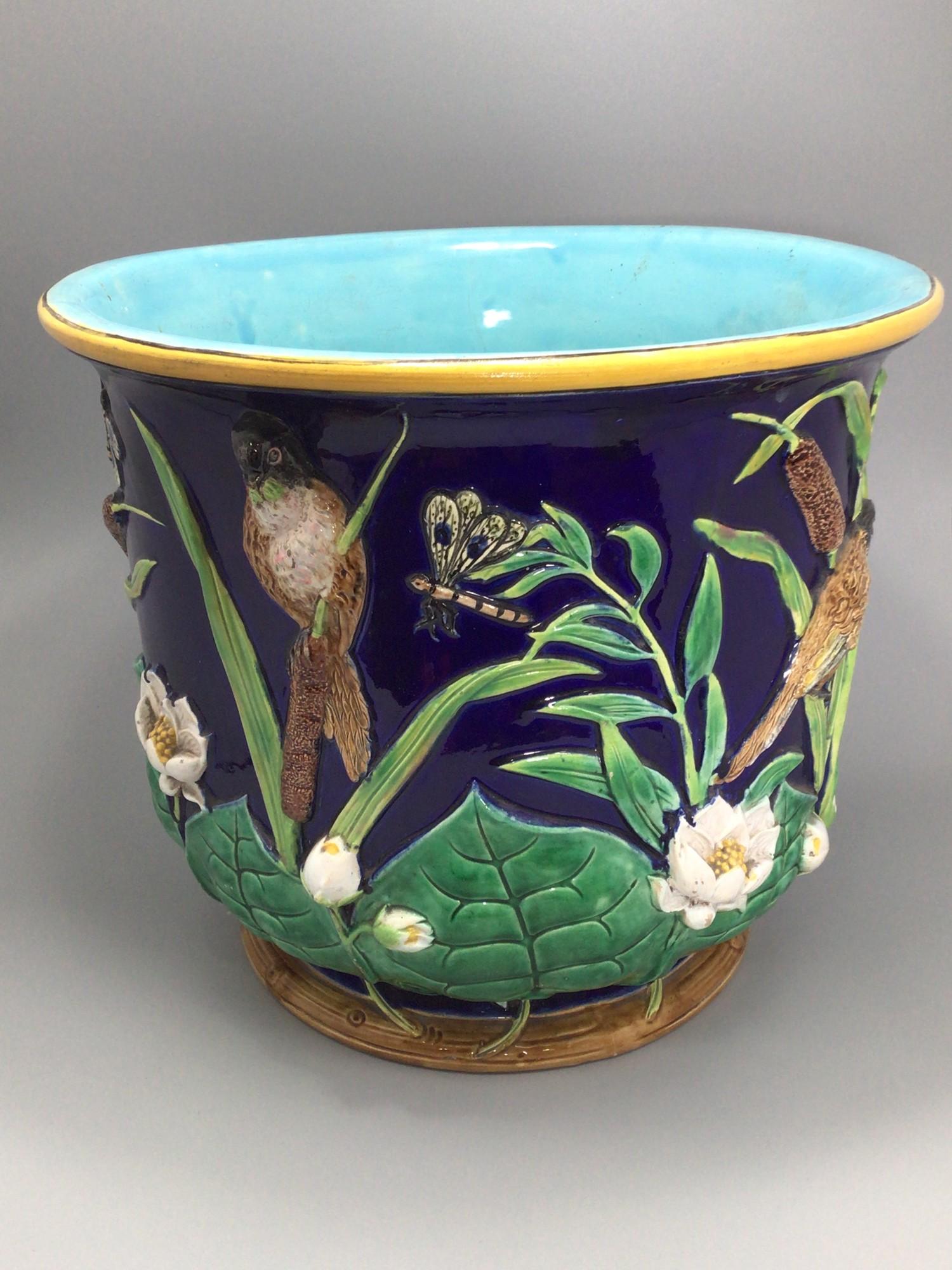 A 19th century Majolica pottery jardiniere, probably by George Jones, decorated in relief with birds