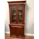 A Victorian mahogany display bookcase cabinet of smaller proportions with two arched shaped glazed