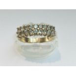 A 14ct yellow gold ring set with 18 x round white stones, ring weighs 4.5 grams, finger size P.