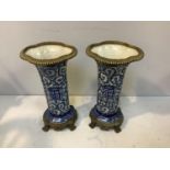 A pair of Chinese blue and white porcelain vases, with gilt metal mounted rims and raised on