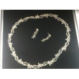 A silver marcasite necklace in a floral and swirl design with matching silver marcasite earrings,