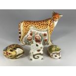 Four Royal Crown Derby porcelain animal paperweights including a Cheetah, a hedgehog 'Primrose'