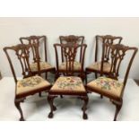 A set of six Chippendale style mahogany dining chairs, the rectangular backs with scrolling cresting